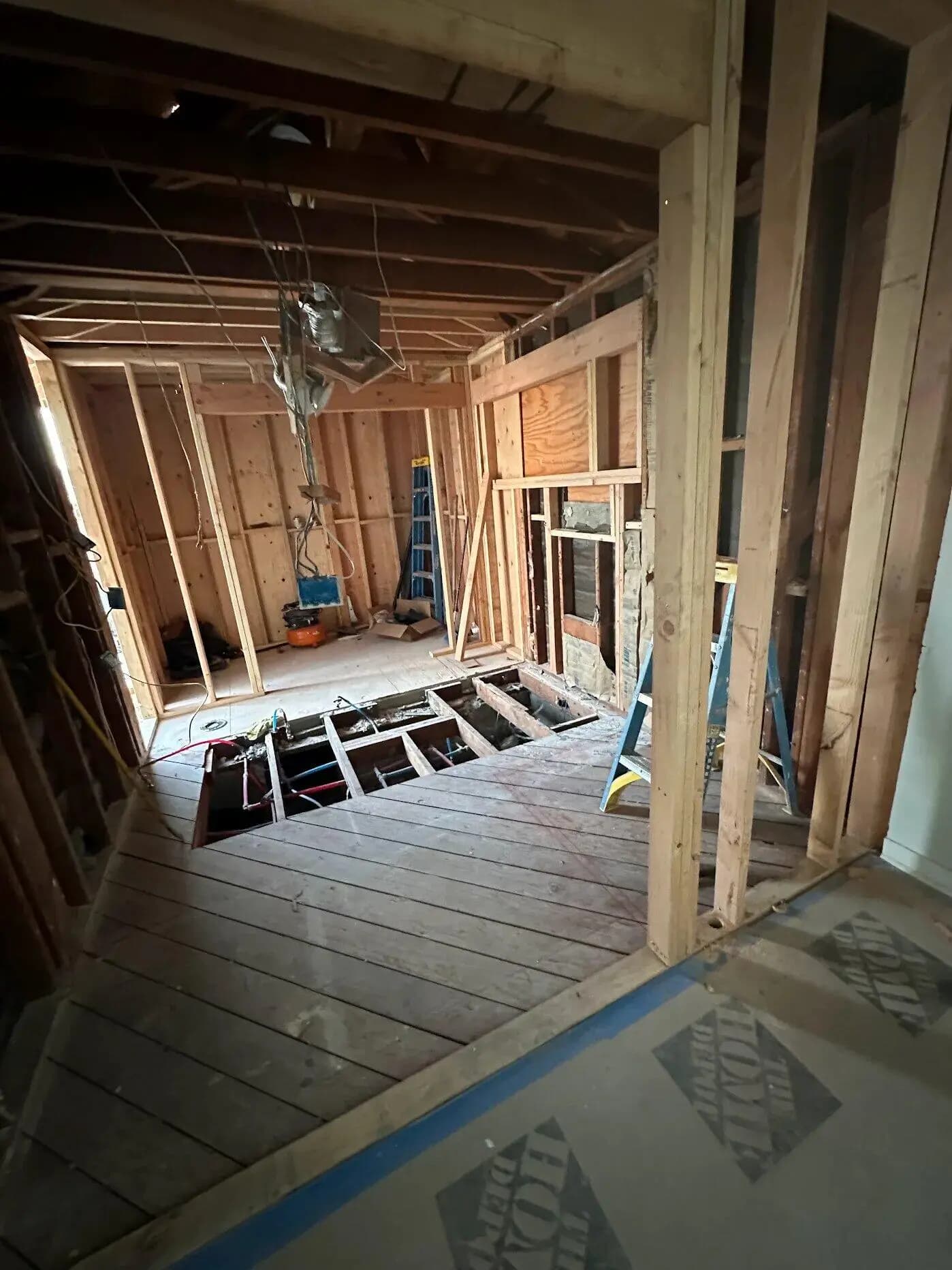 Spacious walk-in closet with custom shelving and organized storage in Long Beach master suite addition