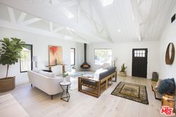 Living room with vaulted ceilings and white oak floors