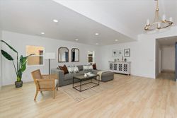 Bright living room with European oak flooring and arched mirrors