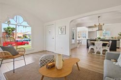 Open-concept living and dining area with vaulted ceiling