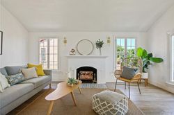 Light-filled living room with restored fireplace